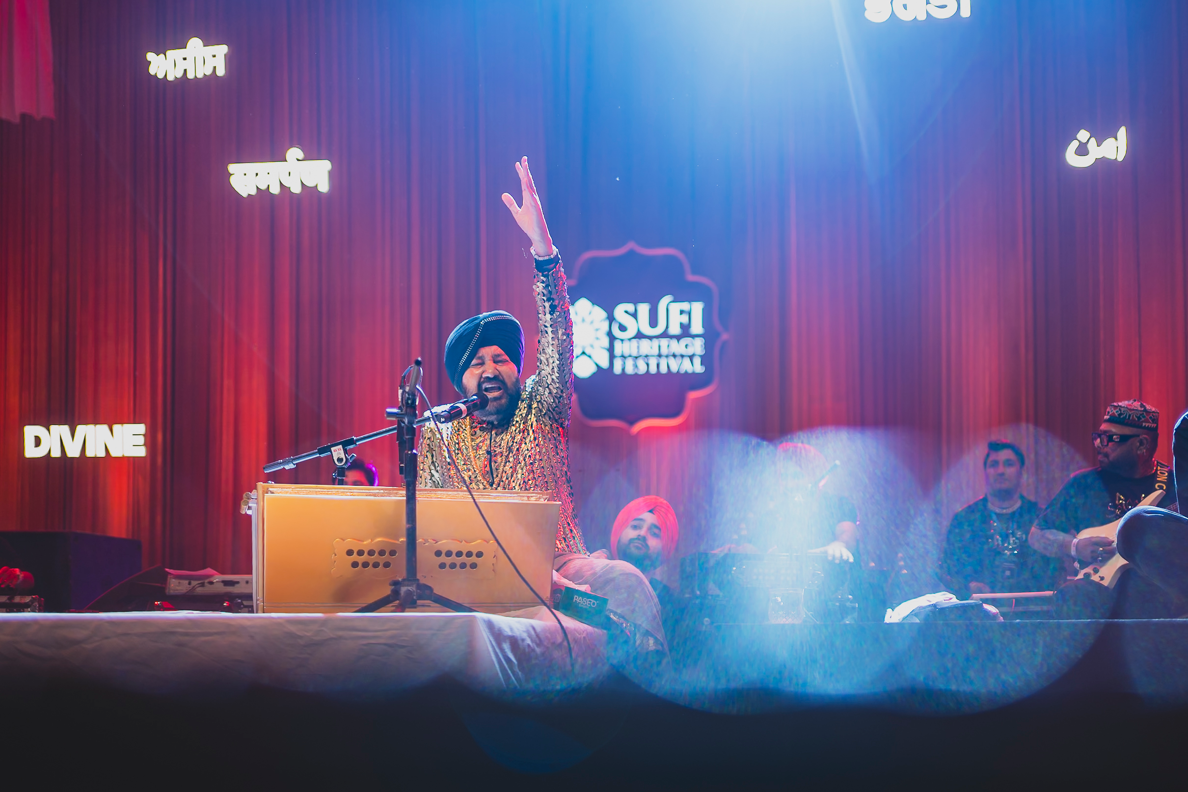 An intimate live performance in blue and red stage light